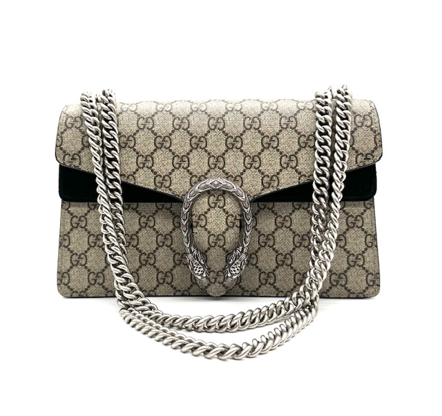 Bolso Dyonisus beige con estampado monogram y detalles de ante negro.