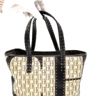 Bolso Carolina Herrera, combinado en cuero marron y tejido icónico de Carolina Herrera.