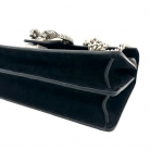 Bolso Dyonisus beige con estampado monogram y detalles de ante negro.