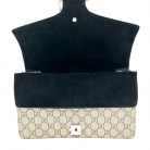 Bolso Dyonisus beige con estampado monogram y detalles de ante negro.