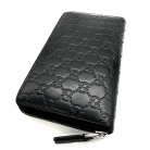 Monedero Gucci en piel negra con el icónico estampado Guccissima