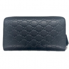 Monedero Gucci en piel negra con el icónico estampado Guccissima