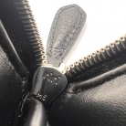 Prada portafoglio zip-around in pelle nera con logo triangolare