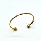 Bracciale Dior in metallo dorato con design aperto
